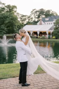 gorgeous couple kissing by the pond and fountain